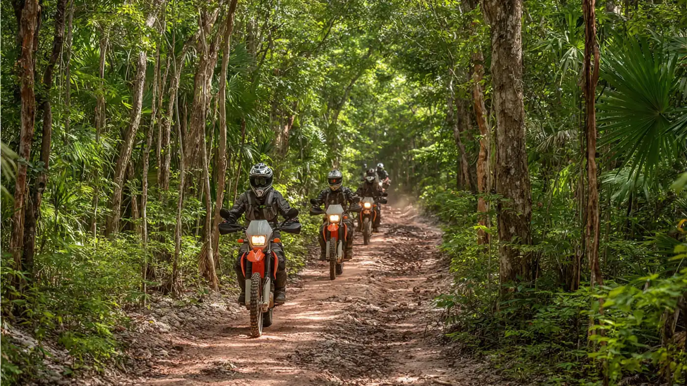Riders on a red dirt trail through the jungle near Cancún